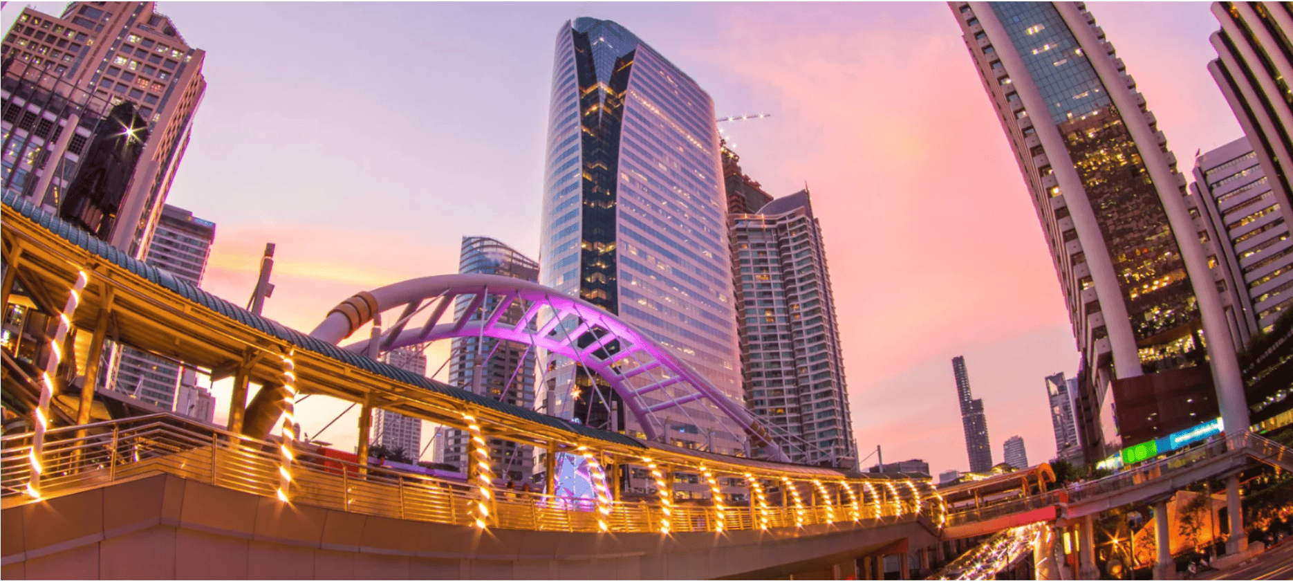 Bangkok skyline at sunset over Sathorn skywalk and skyscrapers