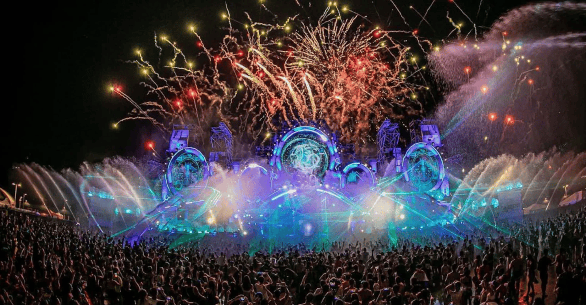 Outdoor music festival main stage with fireworks and laser lights