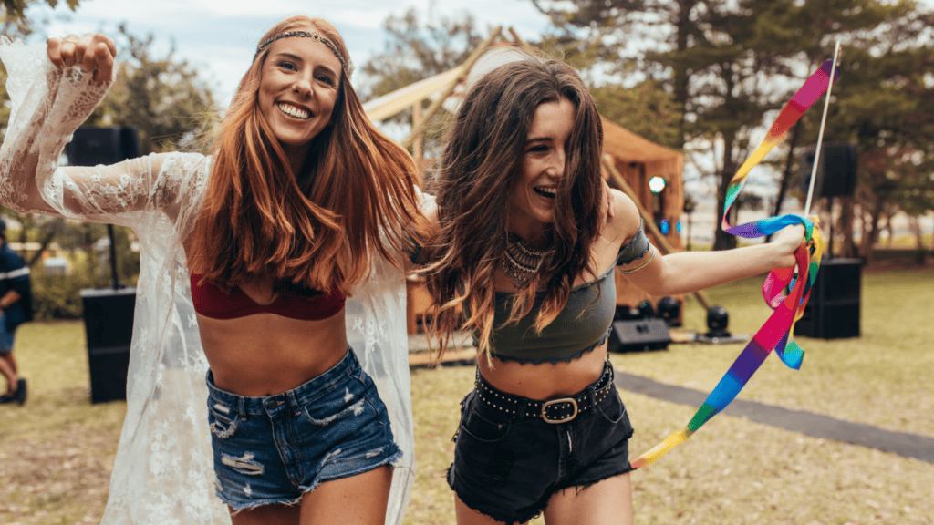 2 young women enjoying cannabis products at a festival